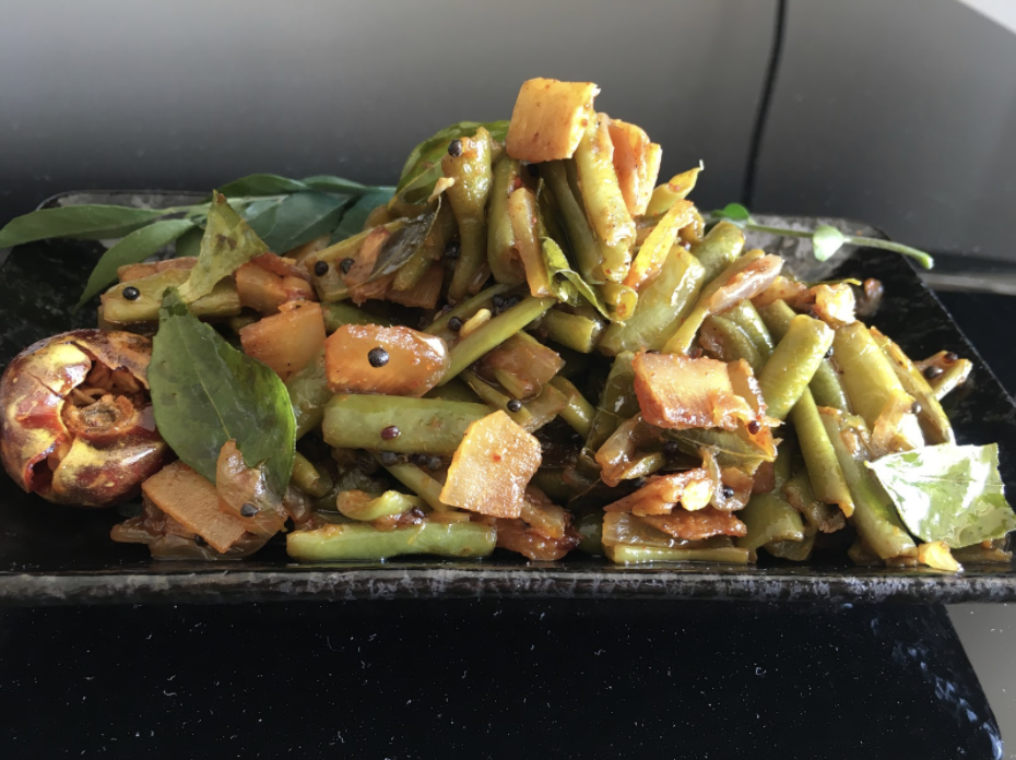 Kerala Style Beans Mezhukkupuratti Delicious Stir Fried French Beans with coconut chips and curry leaves.