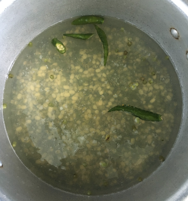 Boil and cook the Moong until soft Dry roast cloves, pepper, coriander seeds on low flame for 1min.Add half of the fresh grated coconut and dry red chilies. Dry roast until coconut turns light brown in color