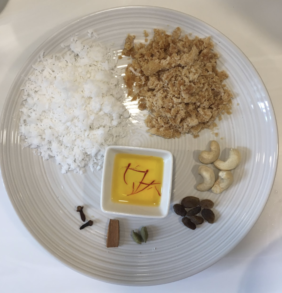 1cup basmati rice 1cup jaggery 1cup coconut milk ½ cup coconut( fresh, grated) 2-3 tsp ghee ½ tsp nutmeg powder 2-3 cloves 1small piece of cinnamon 2-3 green cardamom Few cashews and raisins Few strands of saffron soaked in water Pinch of salt INSTRUCTIONS wash and soak rice for at least 30 mins Heat up ghee in a pan Fry cashews and raisins. Keep aside In the same pan, add cloves, cinnamon, and cardamom Sauté for 20-30 secs Add the soaked and drained rice