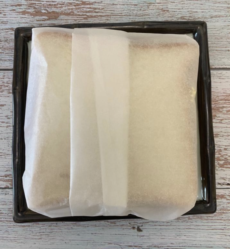 Now cut the sandwich over the paper in the center Your Gigantic Wanpaku sandwich is ready