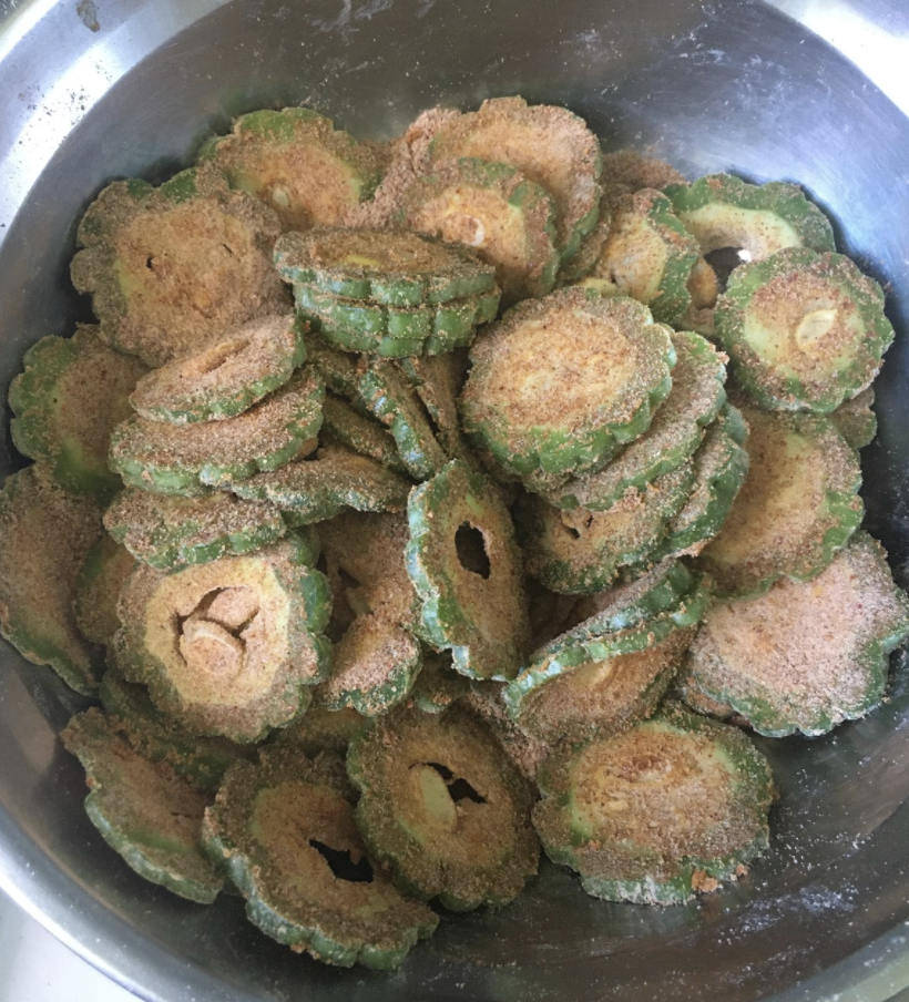 Add 1-2 tbsp oil and evenly coat the masala onto the slices