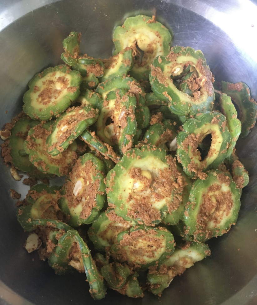 Preheat oven to 350-400 F Line a baking tray and neatly arrange all the Karela slices on it