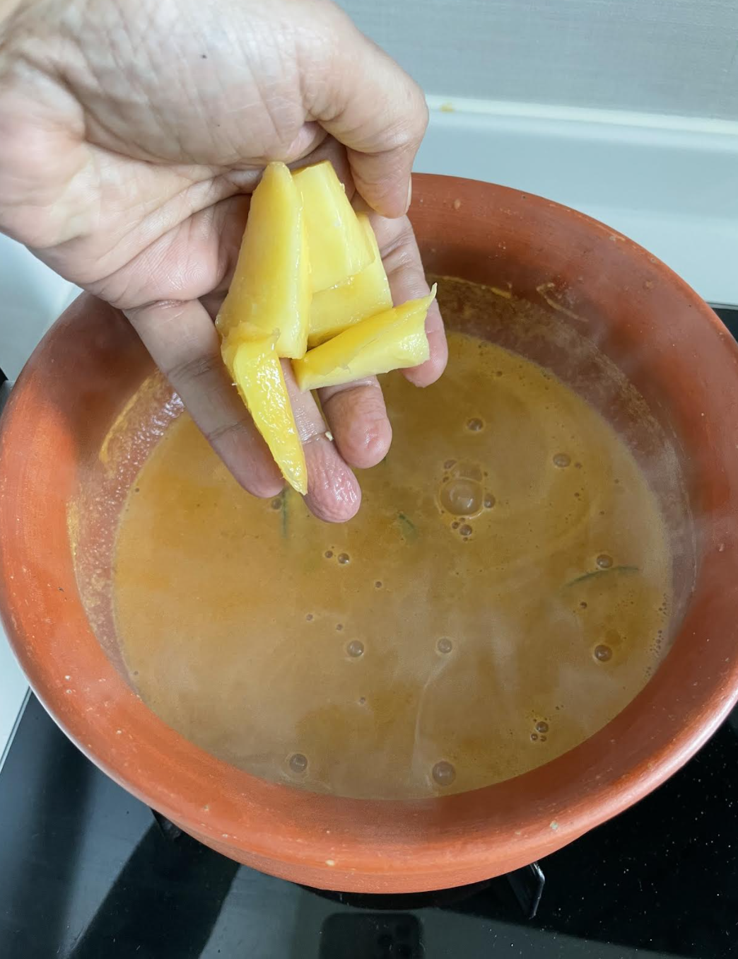 Adding prawns to the curry
