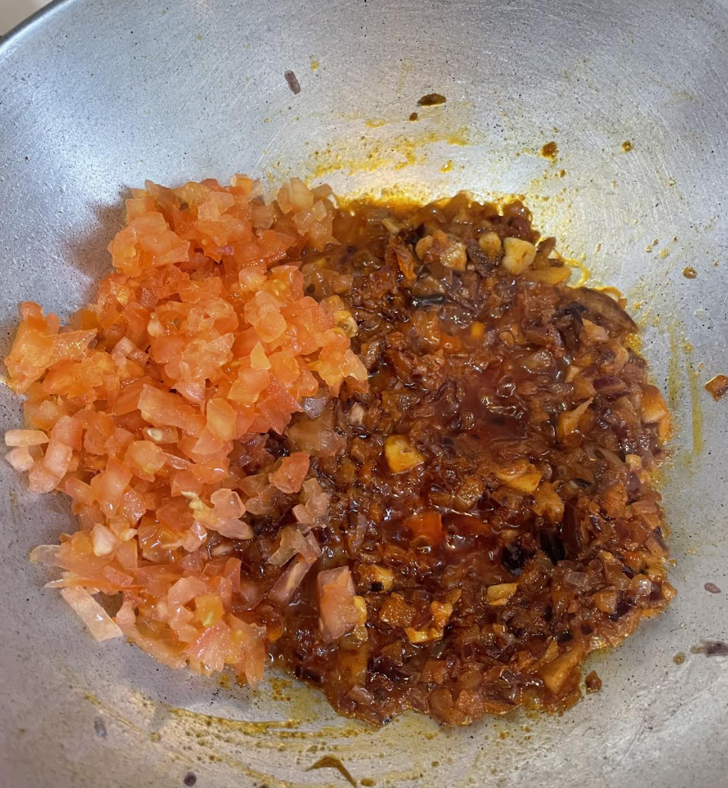 Cooking the masala with paneer paste