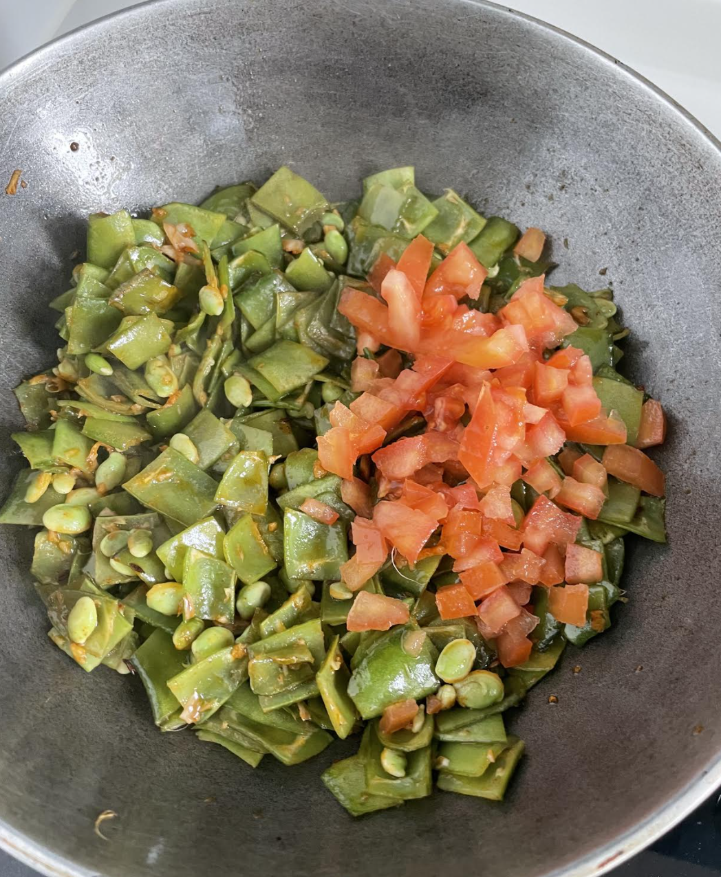 Adding spices to papdi bhaji